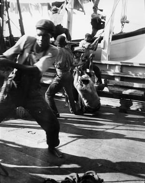 Baleeiros-1974-3-1 photograph of crewmen at work aboard the bark Sunbeam in 1904