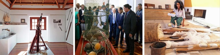 Photo Caption: (left) Eastern wall of the gallery, A Caça à baleia nos mares de Cabo Verde. Harpoons, photo reproductions, model of the Ernestina and other objects were donated to Museu da Pesca by the New Bedford Whaling Museum. (middle) Inauguration of Museu da Pesca on November 21, 2019.  In front of platform from right to left viewing objects are US Ambassador to Cabo Verde, Jeff Daigle, Prime Minister Dr. Paulo Veiga Secretary of the Maritime Economy, and Joaquim Spencer, better known as “Djack” Pinheiro, owner of SUCLA fisheries and cannery, who donated the building for the museum. (right) New Bedford Whaling Museum Curator of Social History Akeia de Barros Gomes conducting an inventory of exhibition objects at the Museu da Pesca in Cabo Verde in fall 2019.