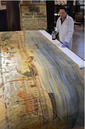 New Bedford Whaling Museum Collections Manager Jordan Berson with the 1,275 foot Purrington-Russell Grand Panorama of a Whaling Voyage Round the World.