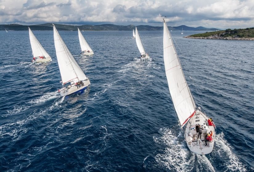 A fleet of sailboats under sail together