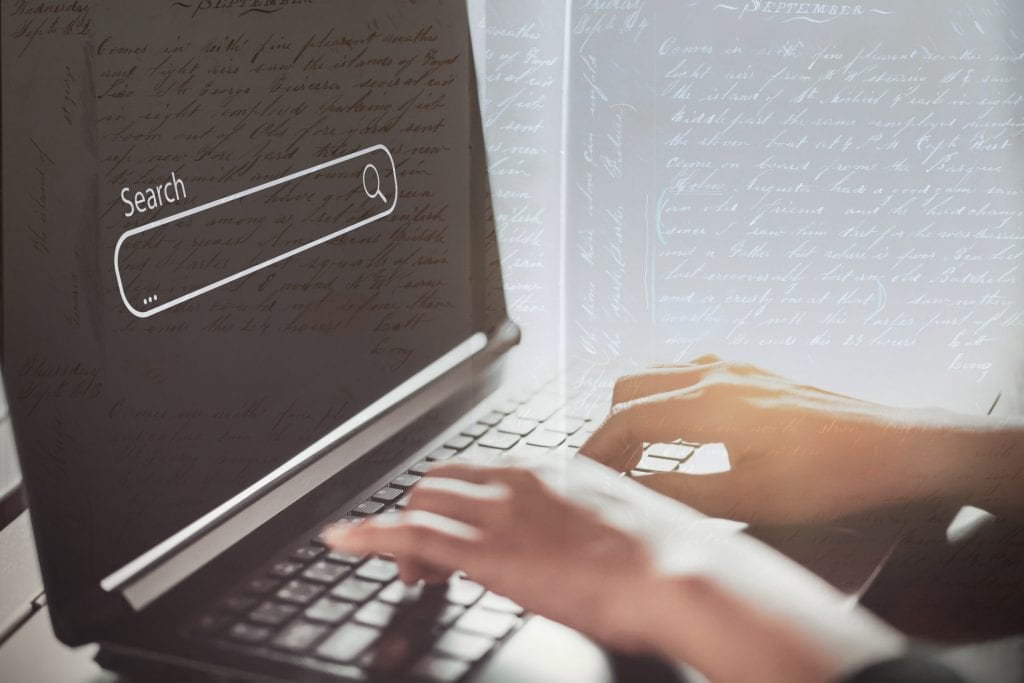 Woman hand using keyboard laptop with search bar icon on screen at coffee shop. Business technology and freelance concept. Woman hand using keyboard laptop with search bar icon on screen at coffee shop. Business technology and freelance concept. Vintage tone filter effect color style.