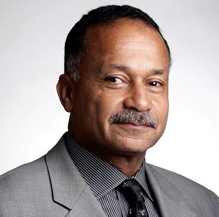 A headshot of an older man looking at the camera with a pleasant expression.