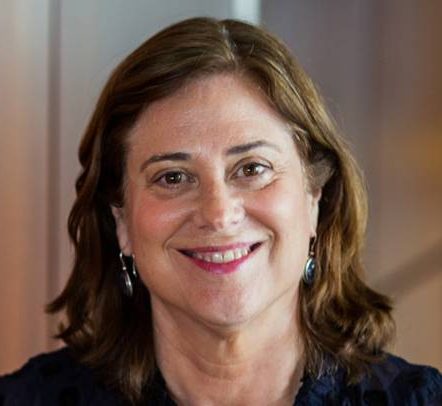 A headshot of a woman looking straight at the camera and smiling.