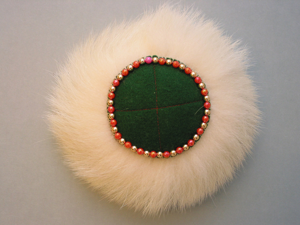 Elizabeth A. Patkotak, Pincushion, 2000. Polar bear fur, felt, beads, and leather, 2 x 8 inches, 2000.15.1
