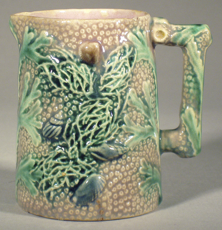 A seaweed themed glazed earthenware creamer.