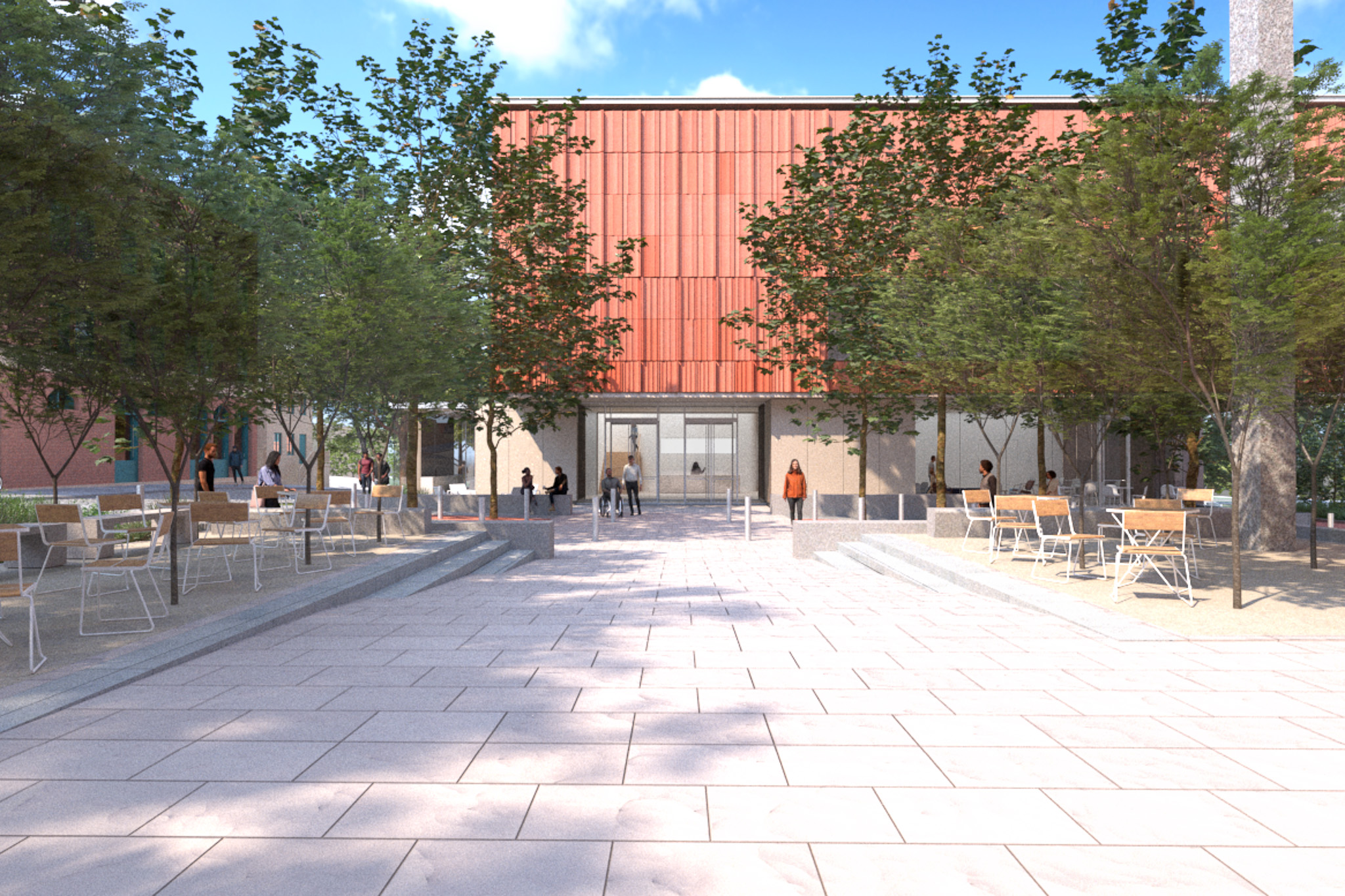 MAIN ENTRY WIDE Architectural rendering of the main entry plaza of a modern building with a red-paneled facade and large glass entrance doors. The spacious courtyard is paved with light-colored stone and features outdoor seating areas with wooden chairs and tables. Trees line the walkway, providing shade, while groups of people walk towards and around the entrance. The surrounding landscaping includes tiered seating and planters, creating a welcoming and open public space under a bright blue sky.