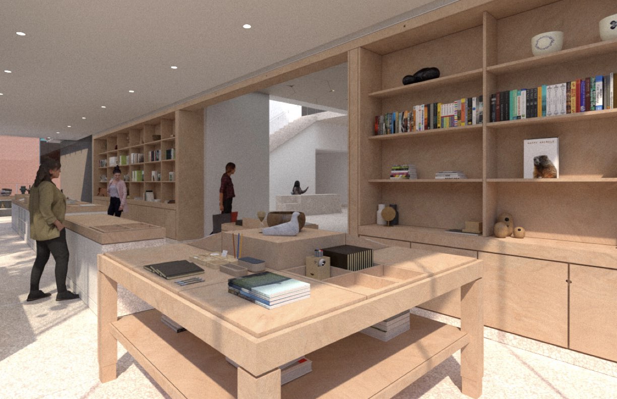 Modern gift shop with wooden shelves, books, and display tables inside a well-lit museum space.