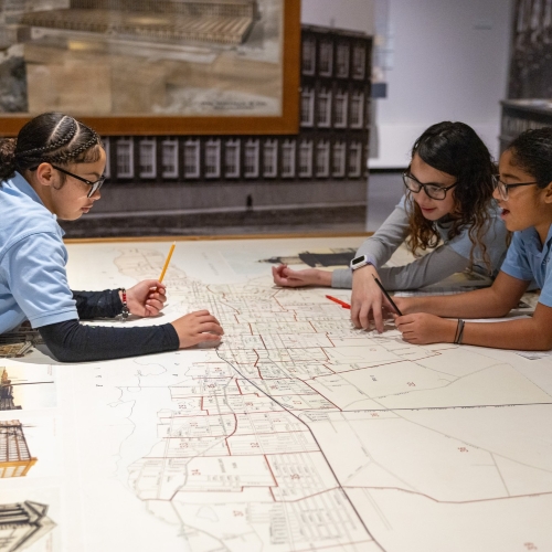 Students looking at a historic map.